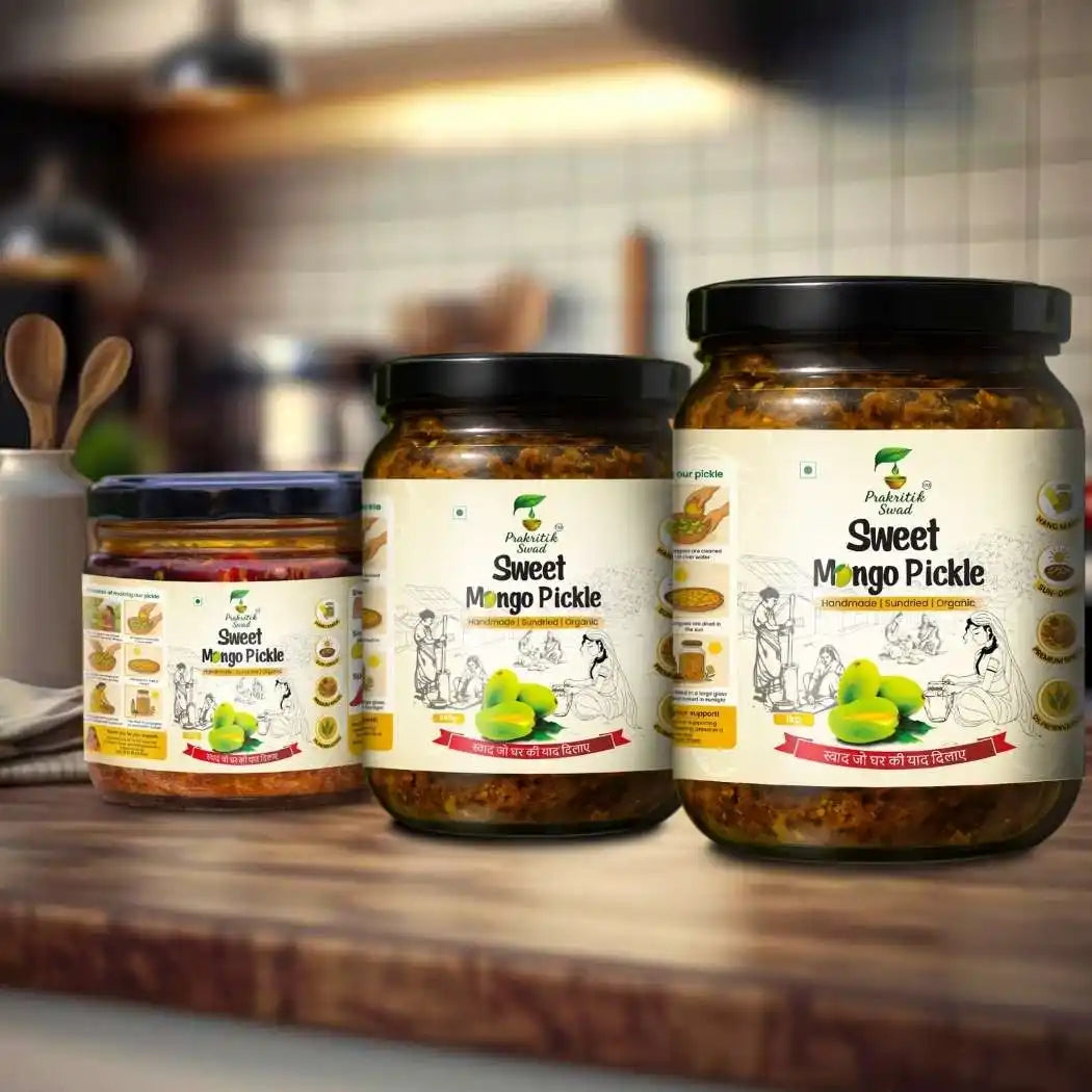 Three jars of Sweet Mango Pickle on a wooden surface with a kitchen background.