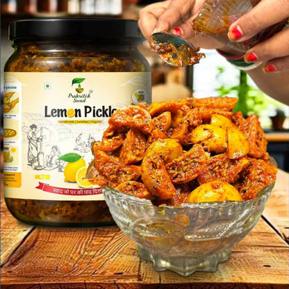 Jar of Prakash Swar Lemon Pickle with a bowl of pickled vegetables on a wooden surface.
