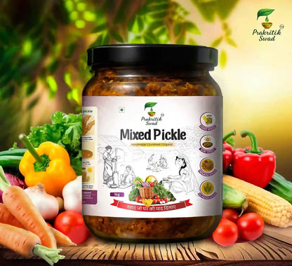 Jar of mixed pickle with a Prakritik Swad label, surrounded by fresh vegetables on a wooden surface.