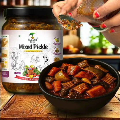 Jar of Prabhuti Sweet Mixed Pickle with a bowl of pickled vegetables on a wooden surface.